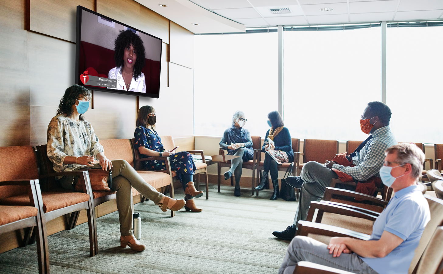A group of patients in a waiting room views content on a digital screen