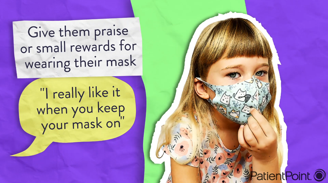 A little girl wears a cloth face mask.