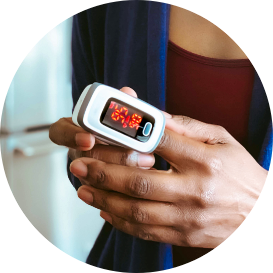 African American woman using a pulse oximeter.