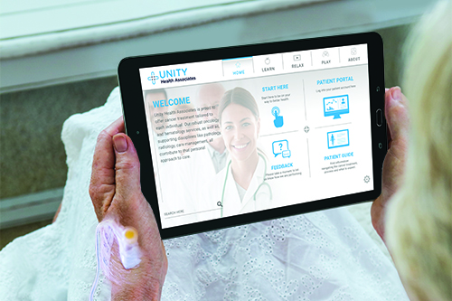 Patient holding a PatientPoint Interact Infusion tablet while getting an infusion treatment.