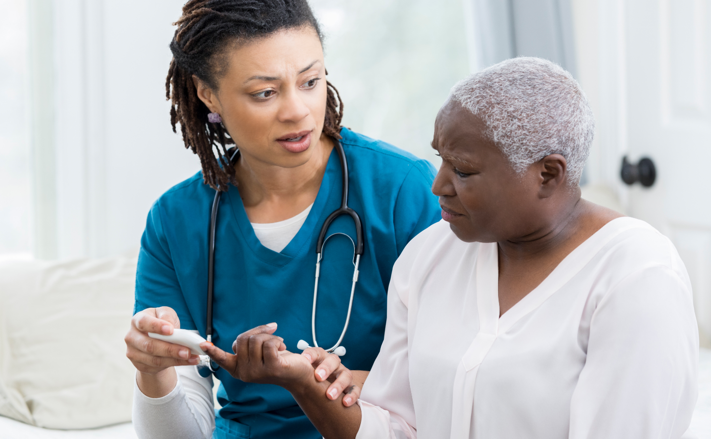 Provider speaking with a patient while placing a device on their finger
