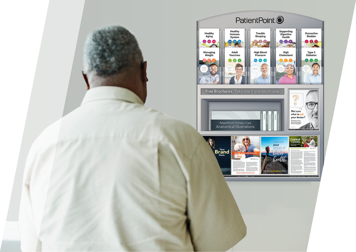 Older, African American male patient in exam room looking at exam room display with print brochures. 