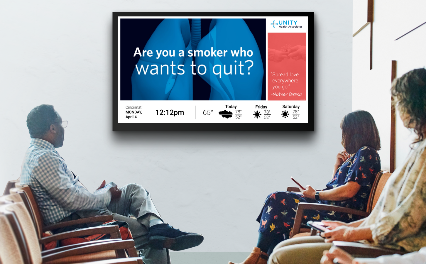 Patients in a waiting room looking at a health message about quitting tobacco. 